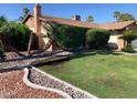Well-maintained front yard with green lawn, mature landscaping, and charming curb appeal at 5821 Santa Catalina Ave, Las Vegas, NV 89108