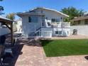 Inviting backyard featuring a raised deck, fenced yard, and well-maintained landscaping at 615 D Ave, Boulder City, NV 89005