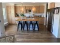 Stylish kitchen with light wood cabinets, a central island, and modern appliances at 615 D Ave, Boulder City, NV 89005