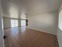 Expansive living room with tile flooring, lots of natural light, and glass sliding doors leading to outdoor space at 6905 Singing Dunes Ln, Las Vegas, NV 89145