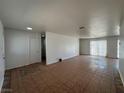 Open-concept living area featuring tile flooring and access to other rooms at 6905 Singing Dunes Ln, Las Vegas, NV 89145