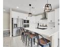 Modern kitchen with white cabinets, stainless steel appliances, and quartz countertops at 7107 Tilligerry St, North Las Vegas, NV 89084