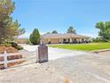 A lovely home with a brick pillar entrance and a large green lawn at 731 W Calvada Blvd, Pahrump, NV 89048