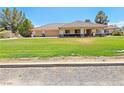 Charming home with a well-manicured lawn and a spacious three-car garage at 731 W Calvada Blvd, Pahrump, NV 89048
