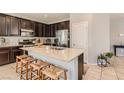 Well-equipped kitchen with granite countertops, a center island, and stainless steel appliances at 7761 Sagamore Bay Ct, Las Vegas, NV 89179
