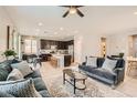 Bright, open-concept living room and kitchen with modern furnishings and neutral decor at 7761 Sagamore Bay Ct, Las Vegas, NV 89179