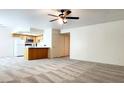 Open-concept living space with an adjacent kitchen featuring a breakfast bar and appliances at 8410 Eldora Ave # 2046, Las Vegas, NV 89117