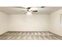 Spacious living room with a ceiling fan and neutral carpeting throughout the home at 8410 Eldora Ave # 2046, Las Vegas, NV 89117