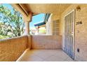 A private patio featuring tiled flooring, a security door, and space for outdoor seating at 8410 Eldora Ave # 2046, Las Vegas, NV 89117