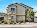 The side view of a two-story home featuring desert-friendly landscaping and a shingle roof at 8754 Brindisi Park Ave, Las Vegas, NV 89148