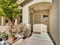 Inviting front porch featuring desert landscaping, a neutral color palette and a secured entrance at 8754 Brindisi Park Ave, Las Vegas, NV 89148
