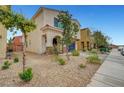 Street view of a two-story home with desert landscaping, a covered entry, and a two-car garage at , Las Vegas, NV 89139