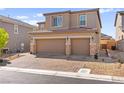 Charming two-story home features a two-car garage and well-manicured front yard at 10101 Heron Lake Ave, Las Vegas, NV 89178