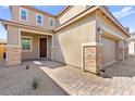 Charming home with brick accents, a two-car garage, and a welcoming front entrance at 10101 Heron Lake Ave, Las Vegas, NV 89178