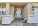 Covered front porch entry featuring updated lighting, and a neutral color palette at 104 Glendive St, Henderson, NV 89012