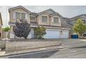 Two-story home with a three-car garage and a well-manicured front yard featuring desert landscaping at 104 Glendive St, Henderson, NV 89012