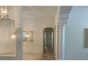 Bright hallway featuring stylish pendant lights and architectural columns at 10816 Elm Ridge Ave, Las Vegas, NV 89144
