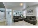 Spacious living room with tile floors, stylish decor, and a comfortable reclining sofa at 11004 Napa Ridge Dr, Las Vegas, NV 89144