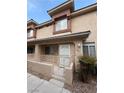 Charming two-story townhome with a private front patio and well-maintained landscaping at 1201 Dusty Creek St, Las Vegas, NV 89128