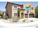 Two-story home with a two-car garage, desert landscaping, and street sign at 176 Jay Porter Ave, Henderson, NV 89002
