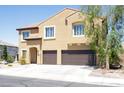 Two-story home features desert landscaping, a two-car garage, and a charming entrance at 176 Jay Porter Ave, Henderson, NV 89002