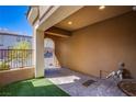 Covered entry with tile, artificial turf, and secure gate, creating a welcoming outdoor space at 1794 Morro Vista Dr, Las Vegas, NV 89135