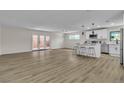 Spacious living room featuring wood floors, plenty of natural light, and an open concept layout at 2211 Frontier Ave, Las Vegas, NV 89106