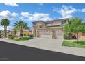 Lovely two-story home featuring a three-car garage, desert landscaping, and great curb appeal at 2382 Sunburst View St, Henderson, NV 89052