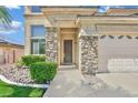 Stunning front entrance of a home with a desert landscape and stone accents at 2382 Sunburst View St, Henderson, NV 89052