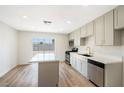 Well-lit kitchen featuring stainless steel appliances and center island, flowing into outdoor access at 239 Concho Dr, Henderson, NV 89015