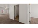 Hallway with neutral walls and flooring leads to additional rooms, offering easy navigation throughout the home at 240 Vineyard Ln, Mesquite, NV 89027