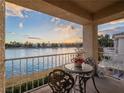 Balcony overlooking a lake with decorative table and chairs perfect for relaxing at 2521 Seascape Dr, Las Vegas, NV 89128
