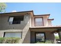Close up of the exterior showing second story deck with railings and window details at 2606 S Durango Dr # 165, Las Vegas, NV 89117
