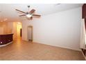 Neutral living room space with tile flooring, a ceiling fan, and access to other areas of the home at 2787 Sunken Ship St, Laughlin, NV 89029
