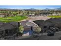 An aerial view of a home near a golf course, showcasing its tiled roof and desert landscaping at 305 Via Del Duomo, Henderson, NV 89011