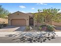 Charming single-story home featuring a desert landscape, and a two car garage on a sunny day at 305 Via Del Duomo, Henderson, NV 89011