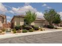 Charming single story stucco home with desert landscaping, an arched entryway and a two-car garage at 3084 Porte La Paz Ave, Henderson, NV 89044