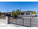 Single-story home featuring mature landscaping, modern fence and xeriscaped front yard at 3308 Navajo Way, Las Vegas, NV 89108