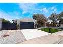 Inviting home featuring a freshly painted two-car garage and manicured front yard at 3572 Tempe St, Las Vegas, NV 89103