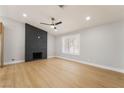 Bright living room featuring new flooring, recessed lighting, and a modern fireplace at 3572 Tempe St, Las Vegas, NV 89103