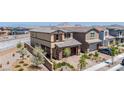 An exterior shot showcases the home's desert landscaping and architecture, next to neighboring properties at 440 Blue Lark Dr, Henderson, NV 89011