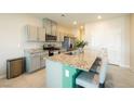 Modern kitchen features granite countertops, stainless steel appliances, and a breakfast bar with seating at 440 Blue Lark Dr, Henderson, NV 89011