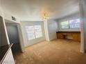 Bonus room featuring built-in desk area with drawers, neutral carpet, and multiple windows at 45 Maleena Mesa St # 1321, Henderson, NV 89074