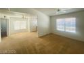 Bright and spacious living room with a ceiling fan and view into another room with neutral tones at 45 Maleena Mesa St # 1321, Henderson, NV 89074