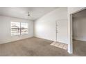 Bright living room featuring plush carpet, neutral walls, and a ceiling fan for a comfortable atmosphere at 45 Maleena Mesa St # 1321, Henderson, NV 89074