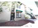 Exterior view showcasing the building's facade, small yard with bark and landscaped surroundings at 450 Elm Dr # 105, Las Vegas, NV 89169