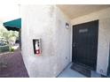 Exterior view of the unit entrance with a black door and fire extinguisher at 450 Elm Dr # 105, Las Vegas, NV 89169
