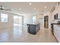 Bright and airy living room featuring tile floors, recessed lighting, and access to the kitchen at 5398 Robinera Ct, Las Vegas, NV 89166