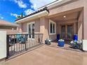 Covered front entrance with an outdoor patio and a view of the intricately designed front doors at 5416 Alabaster Ct, Las Vegas, NV 89149