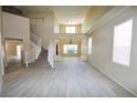 Spacious living room boasts tile floors, neutral paint, staircase and large windows with tons of light at 5808 Amber Station Ave, Las Vegas, NV 89131
